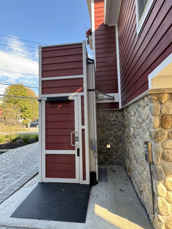 Lift with mast and mounting bracket visible